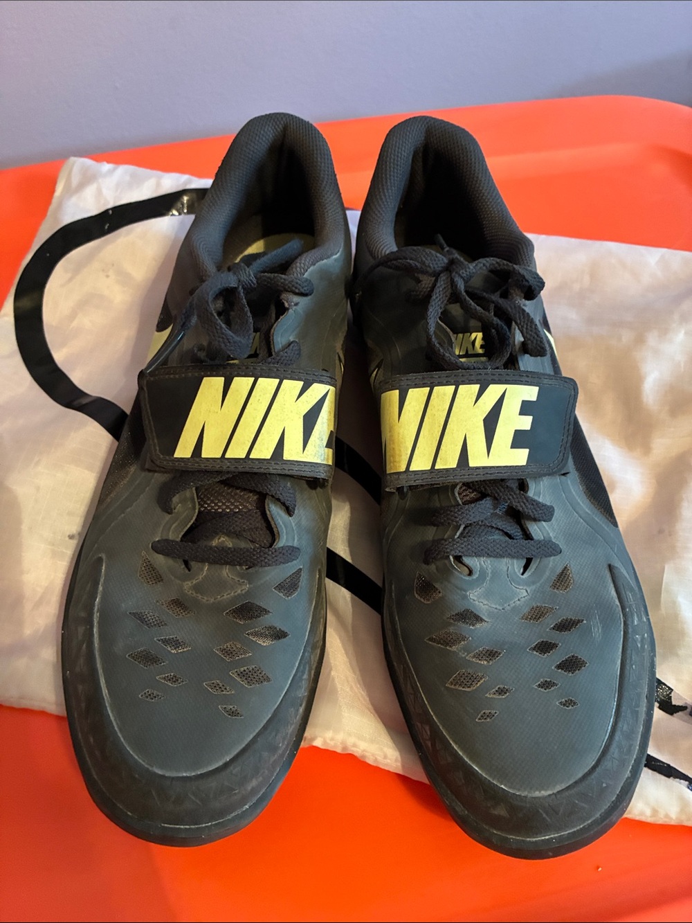 Nike Men’s Black Throwing Shoes with Yellow Logo Strap